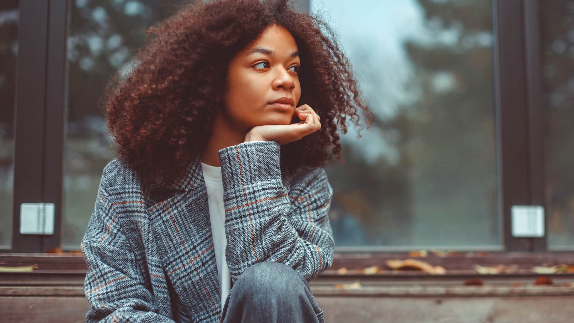 incredibly sensitive woman sitting alone tapping her foot