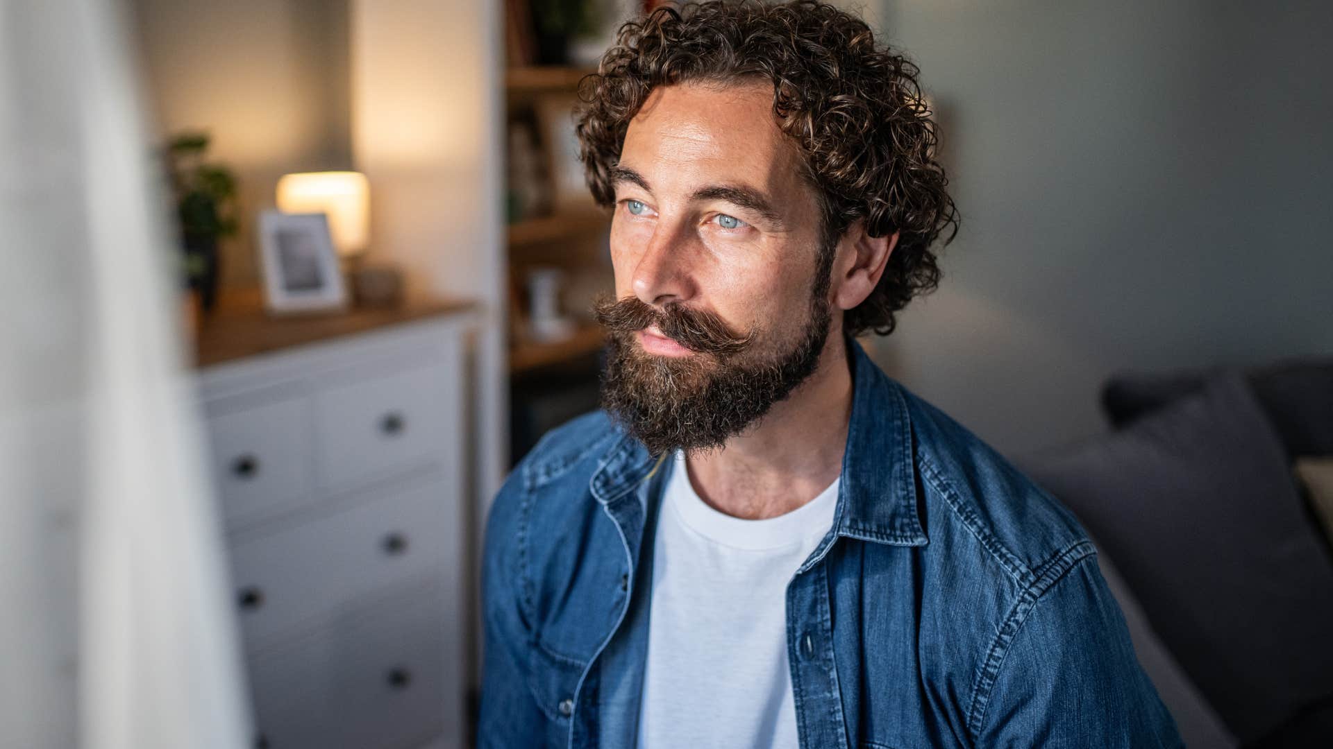 man thinking deeply about things and people standing alone at home