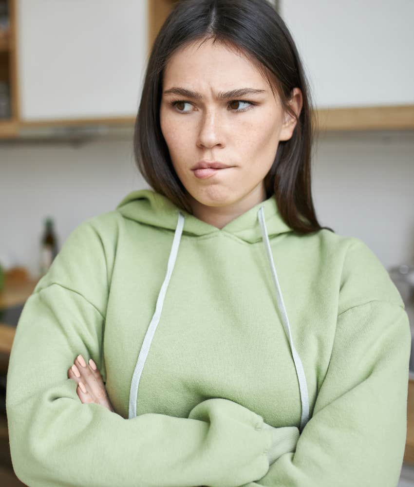 pensive person with arms crossed showing independence due to trauma
