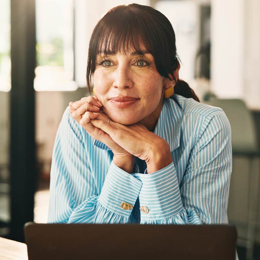 older woman keeping her goals to herself smiling at home