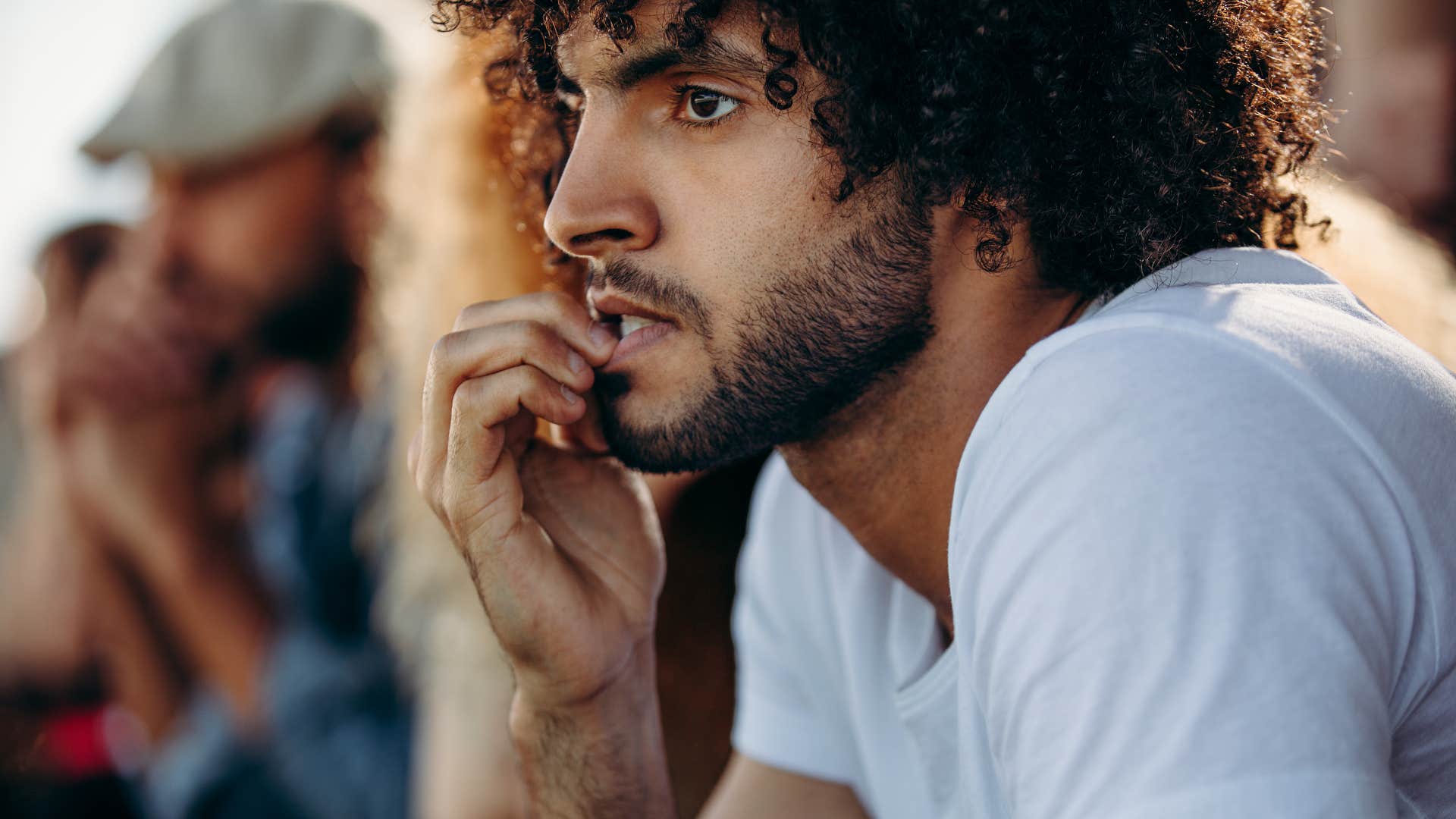 man biting his names trying to avoid harmful coping mechanisms