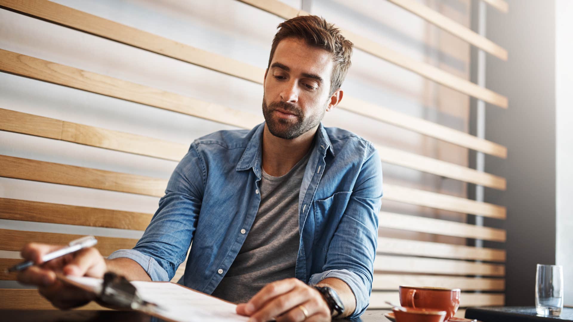 man comfortable making mistakes writing on clipboard