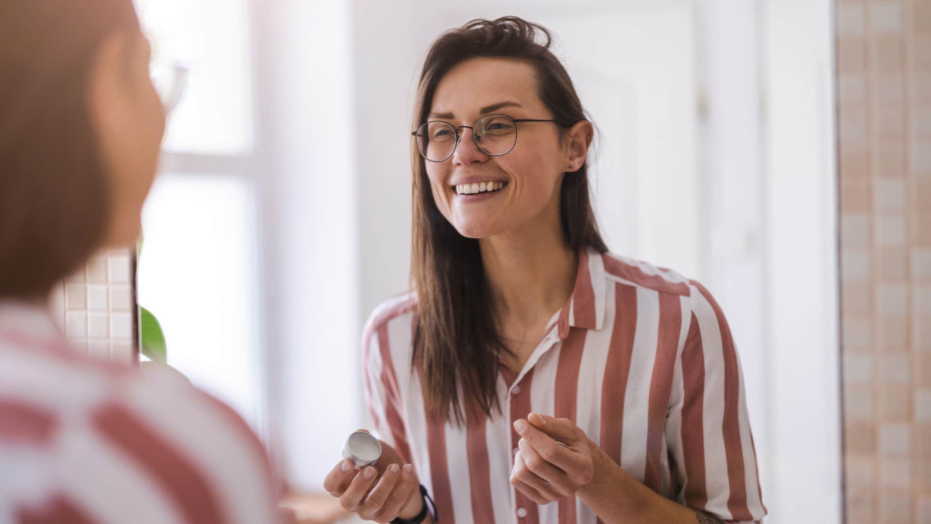 woman with rarest form of intelligence looking in mirror understanding herself fully