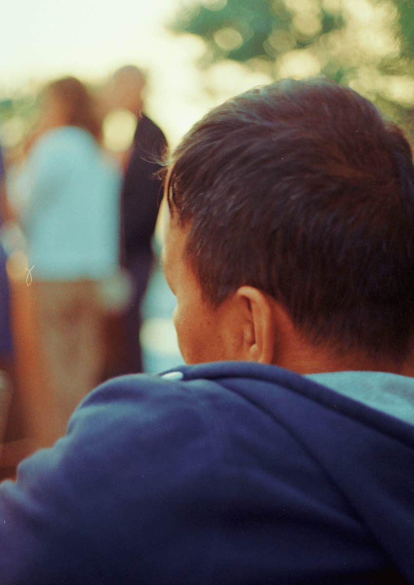 person sitting alone at a family gathering