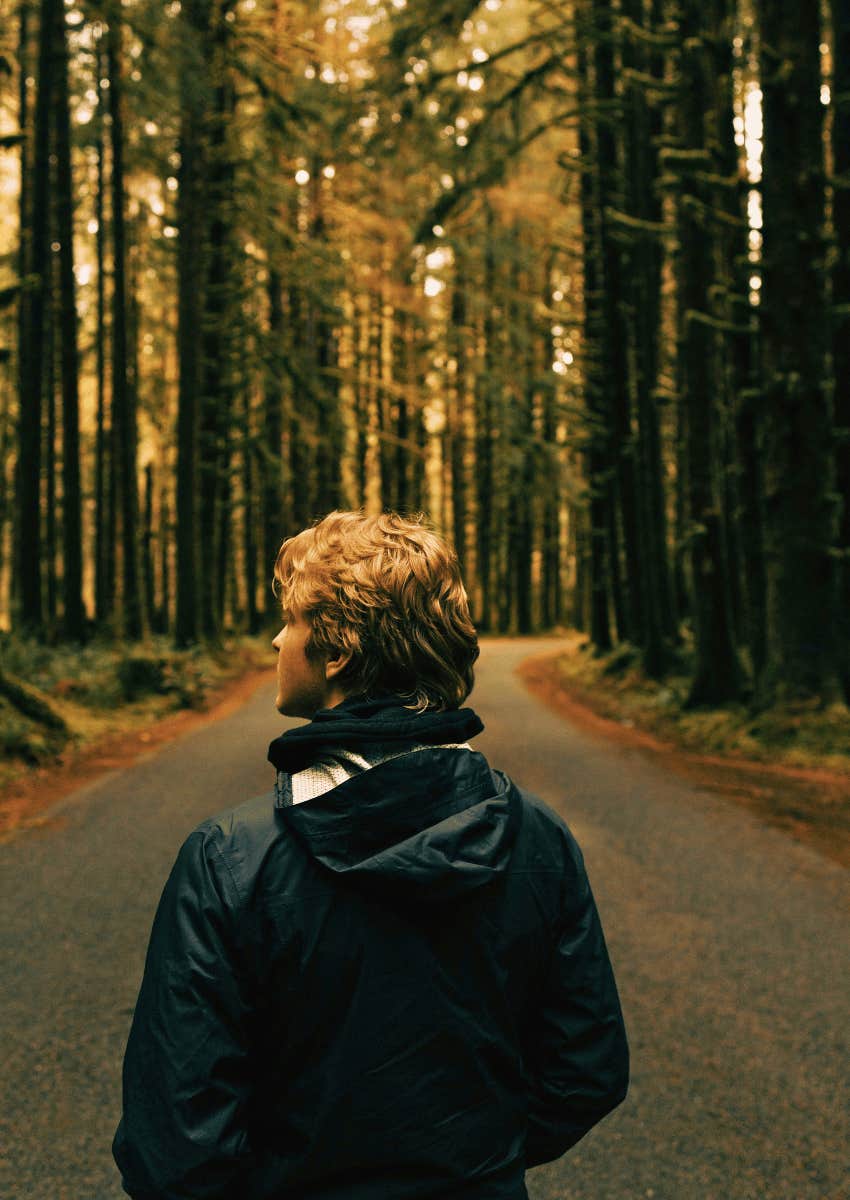 person standing alone on an open road