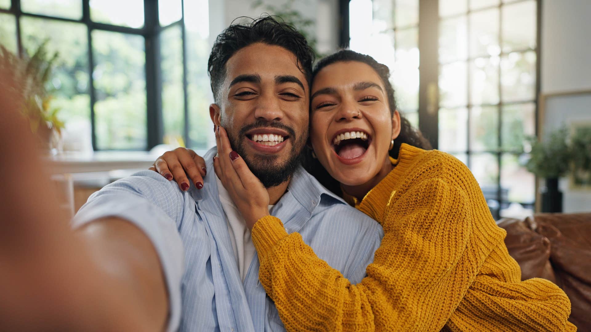 couple smiling while taking picture together
