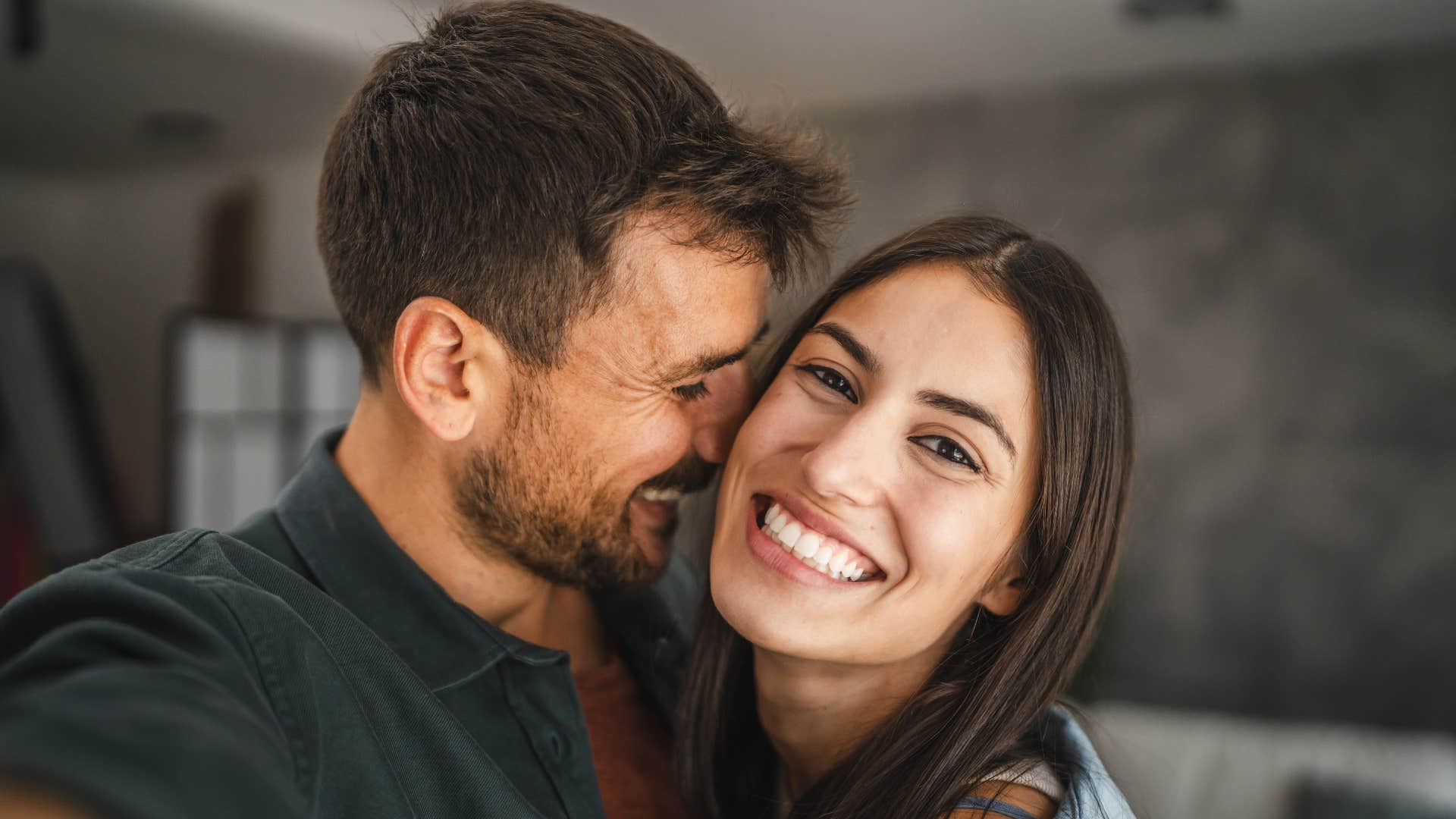 man laughing next to wife