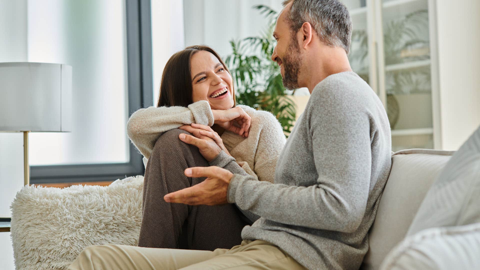 couple having conversation on couch