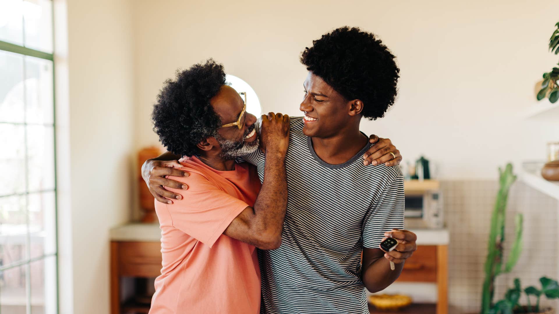 father hugging son offering him support saying i'm here if you need anything