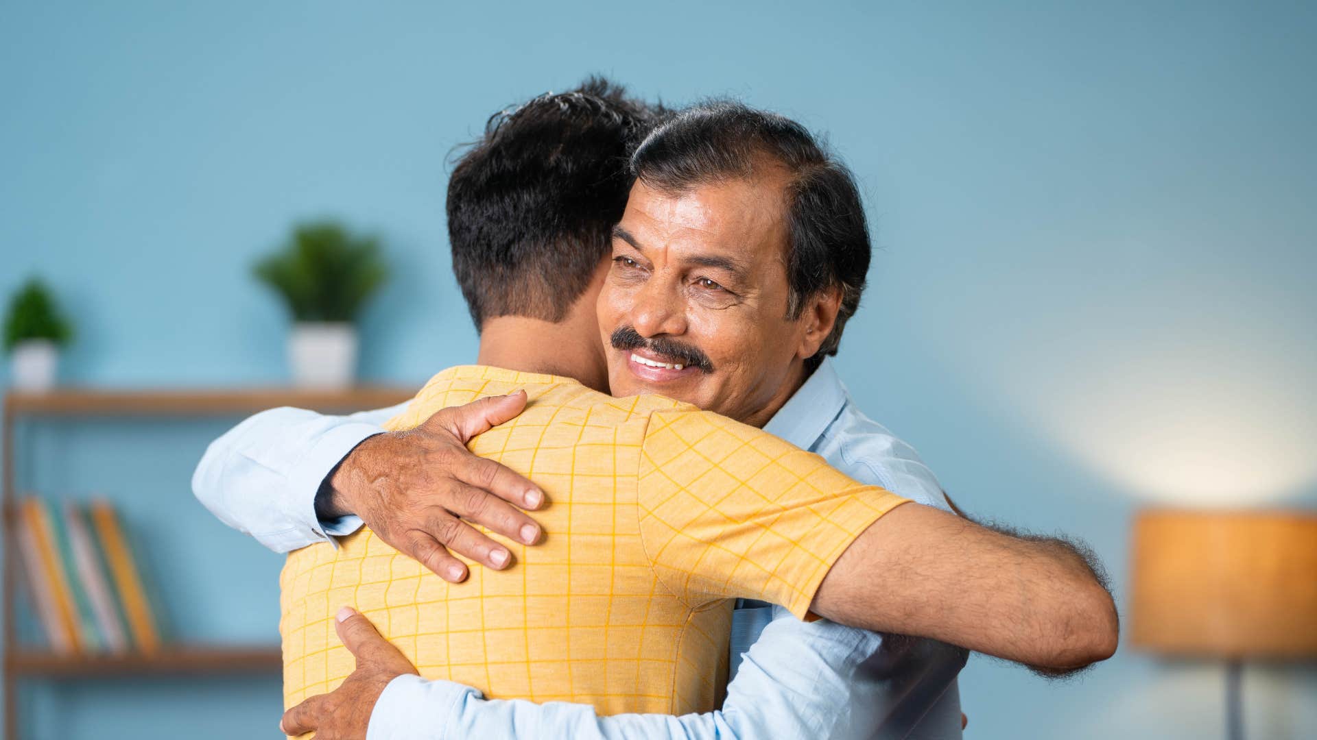 father hugging son smiling as he says take all the time you need