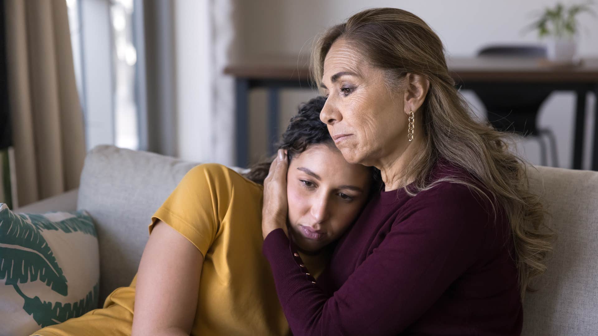 mother hugging adult daughter apologizing to her