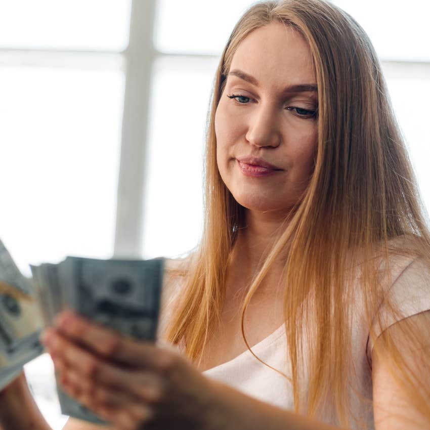 woman holding cash while saying it's basically free money