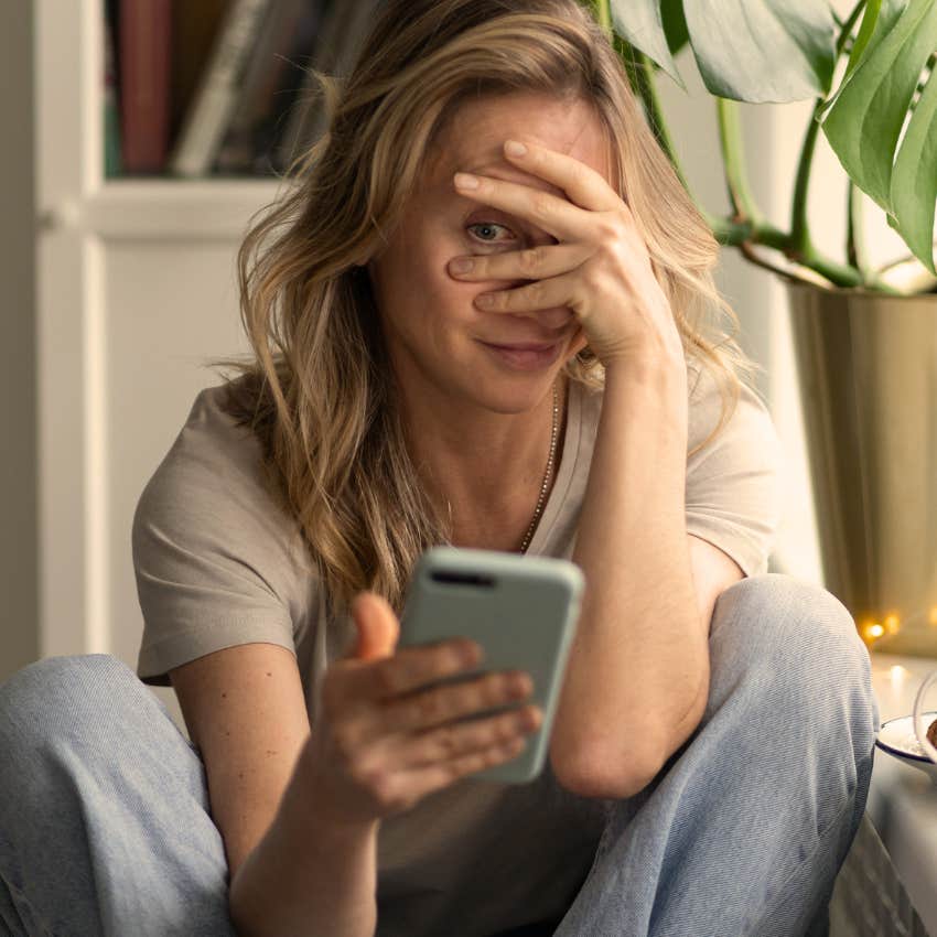 young woman looking at cringey things on her phone saying that's so embarrassing