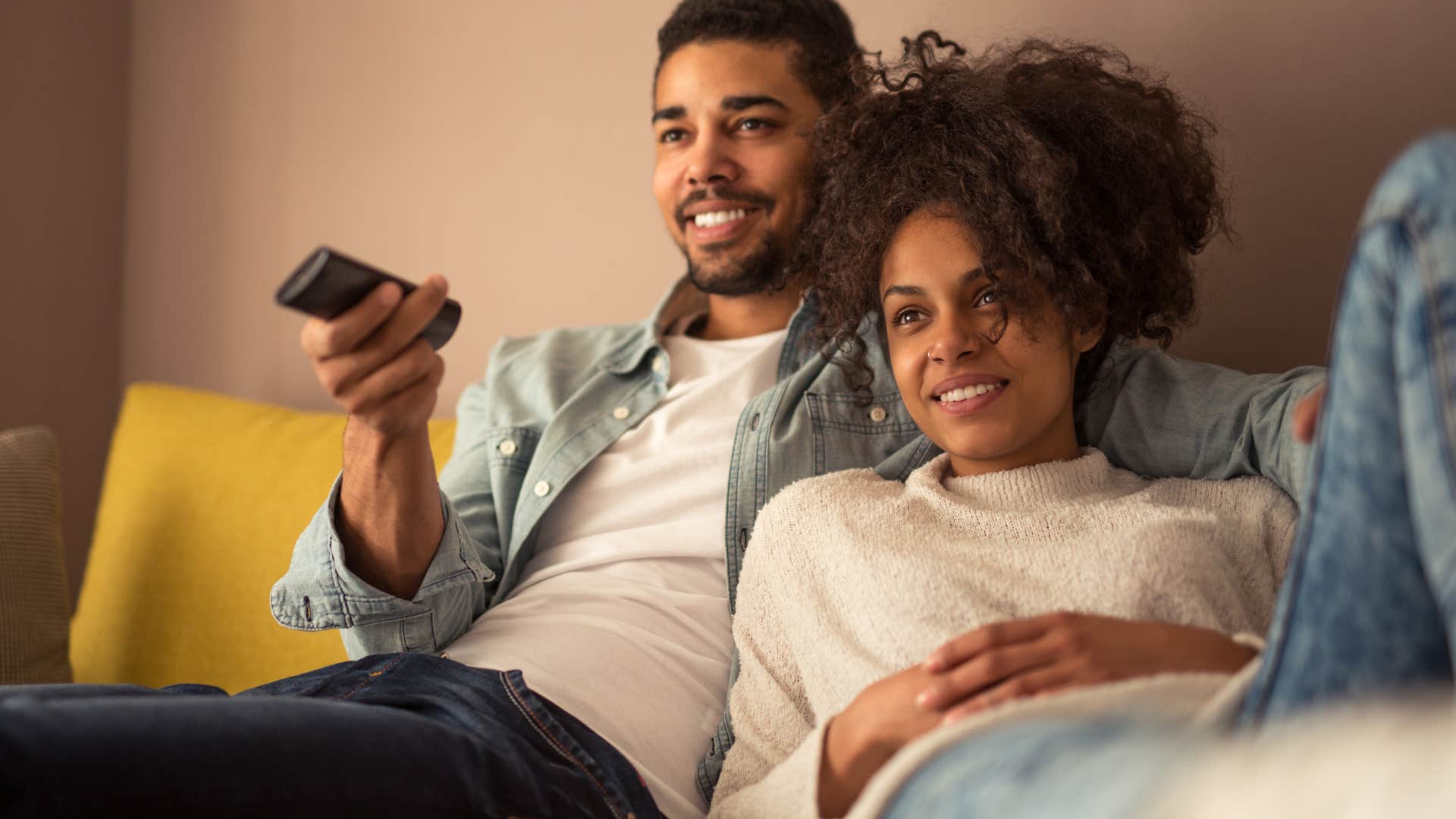 Man who is falling in love stays in to watch TV with the woman he loves
