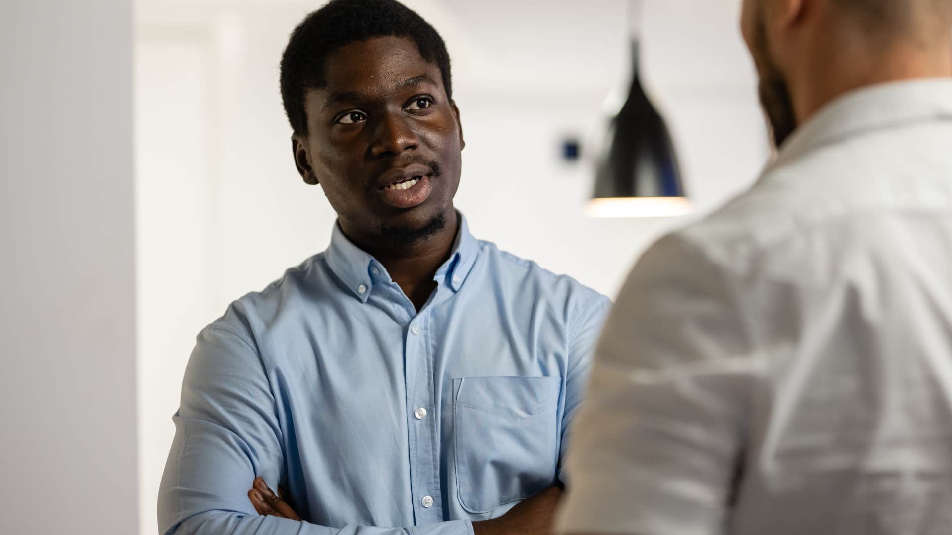 man apologizing to co-worker for interrupting during conversation