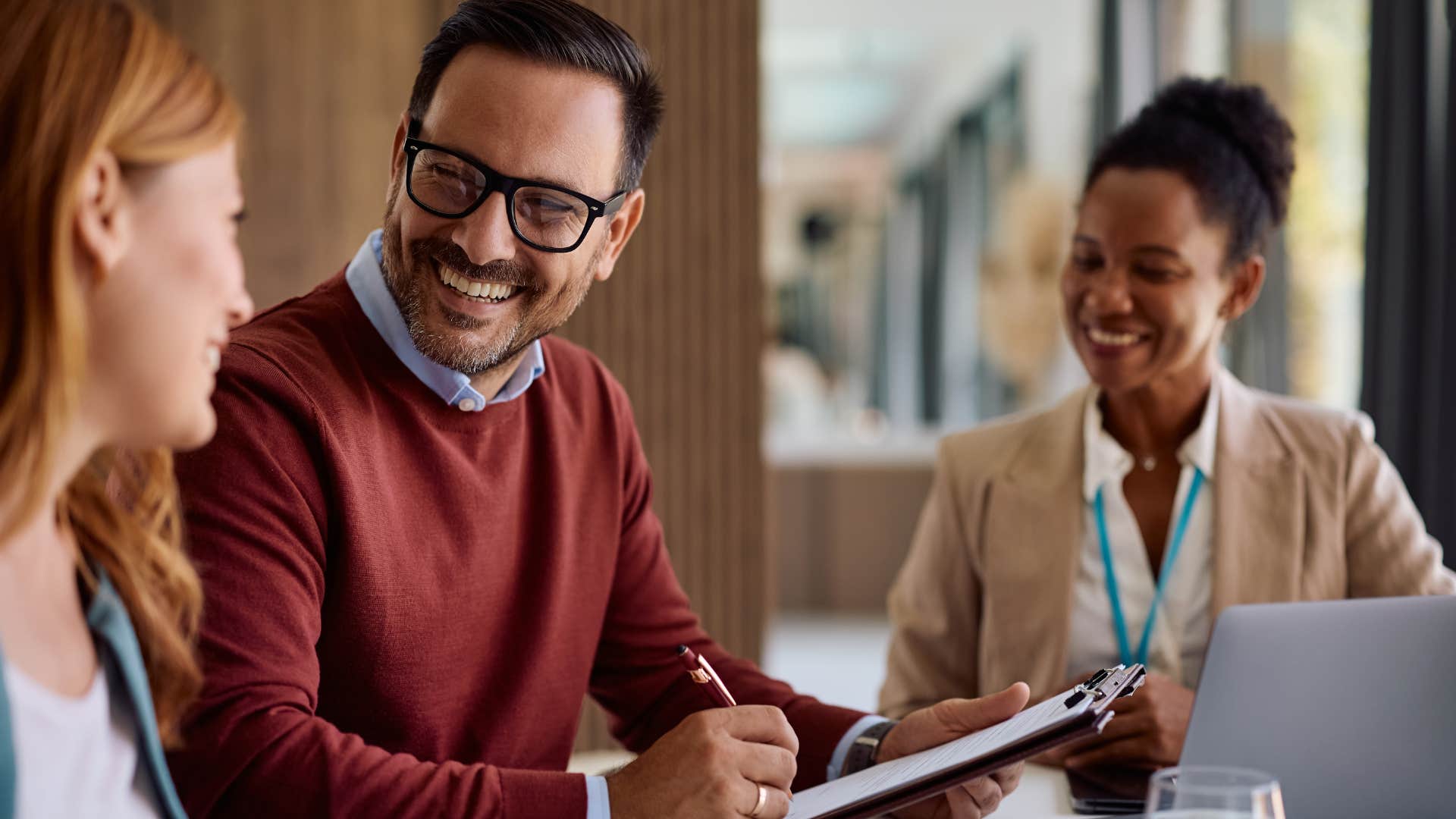 polite man saying please to colleagues at work
