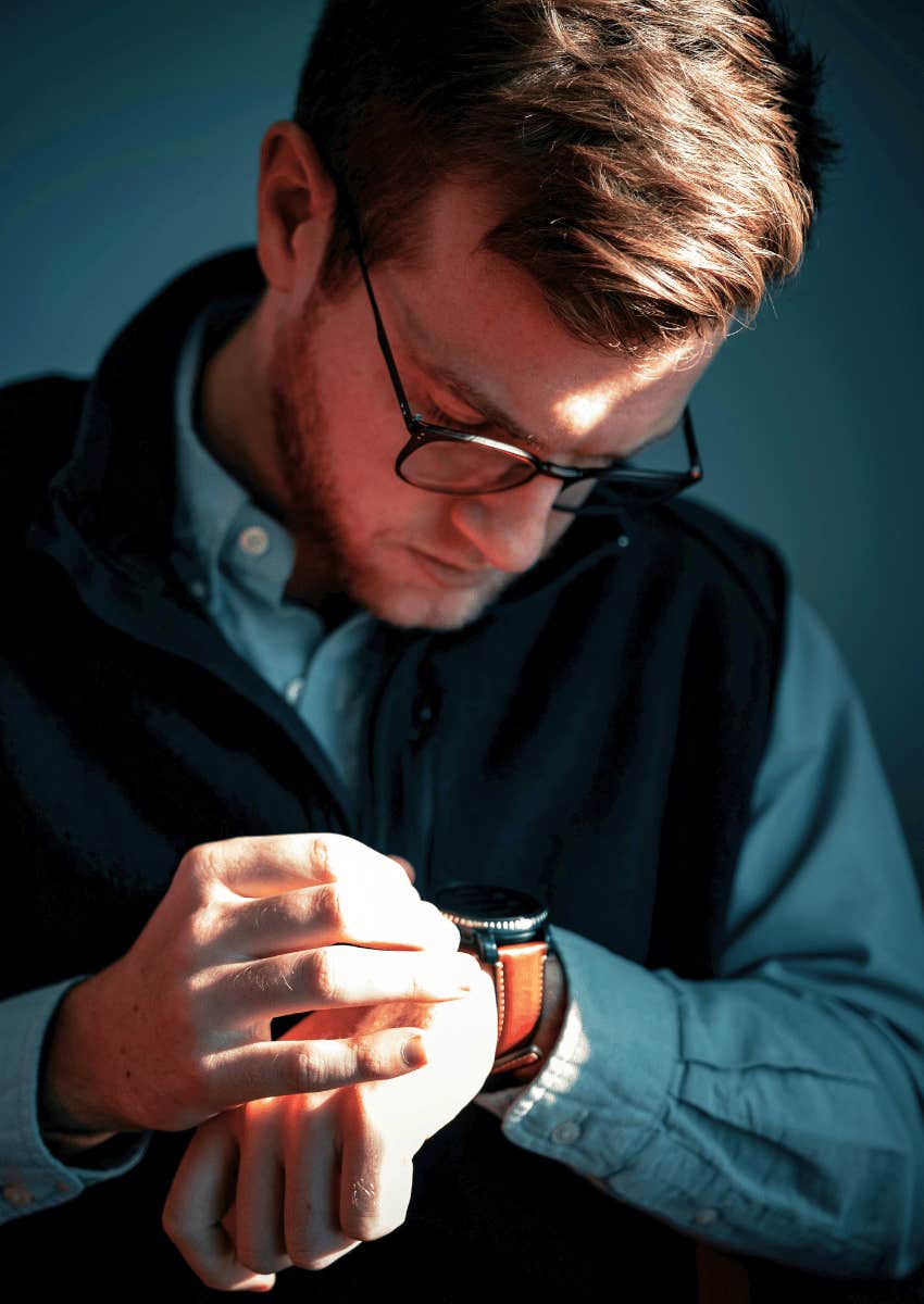 professional man looking down at his watch