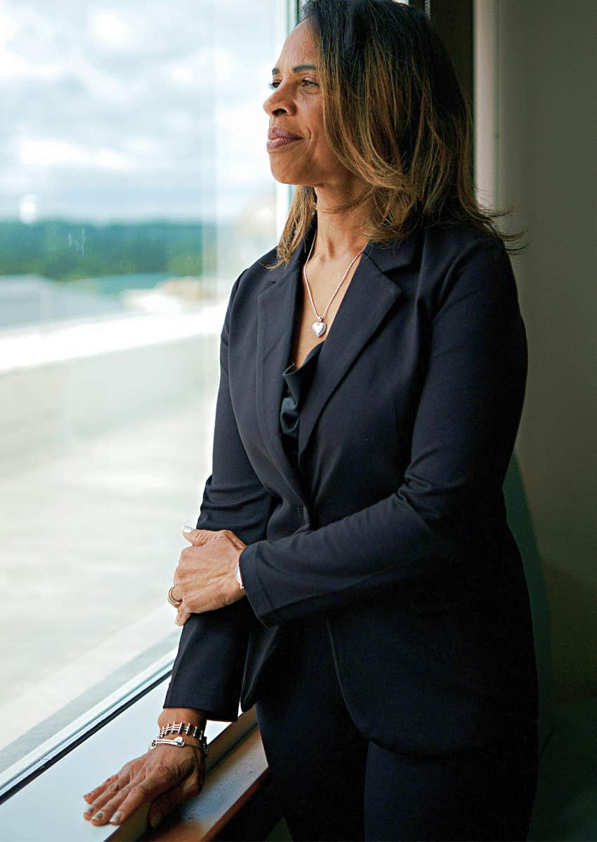 professional middle age woman looking out of window