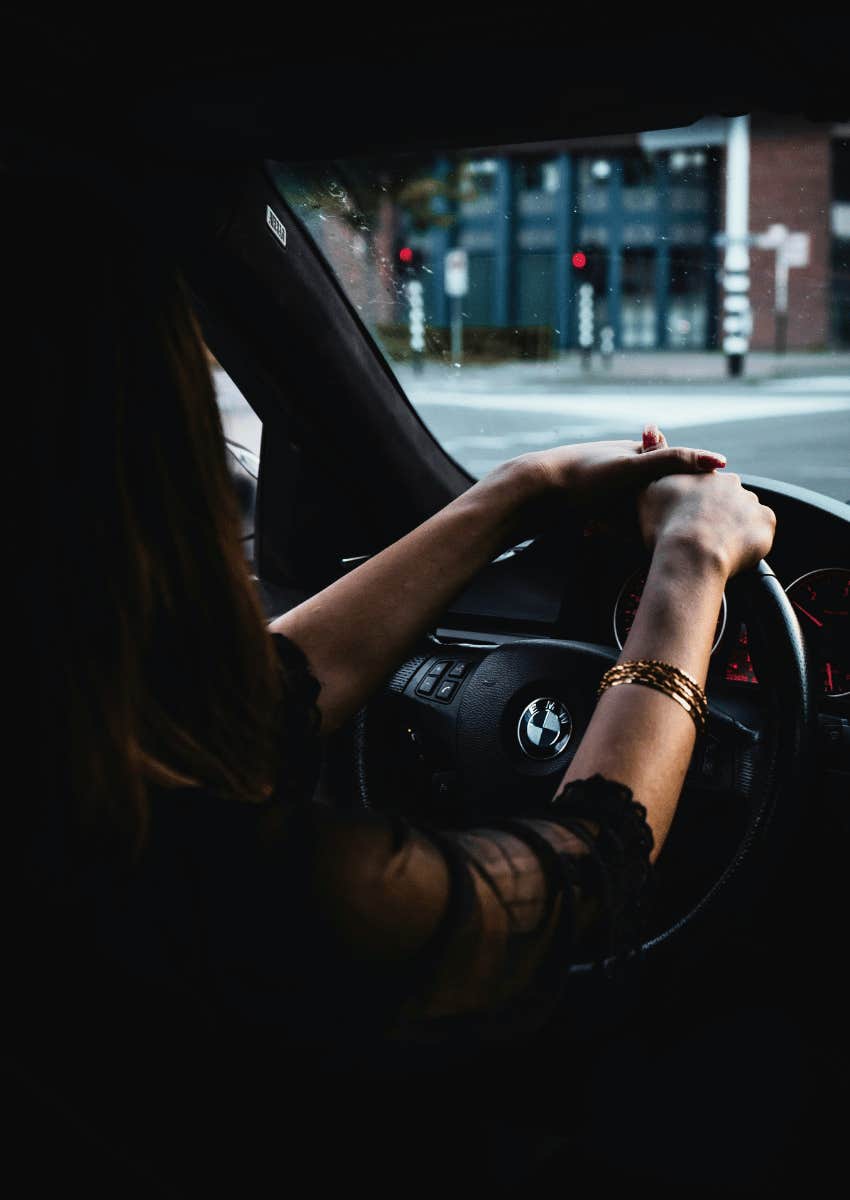 profile of woman driving down road