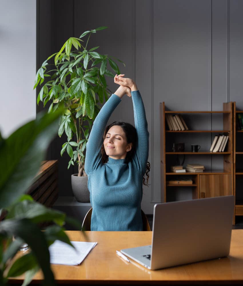 office worker stretches arms to get moving