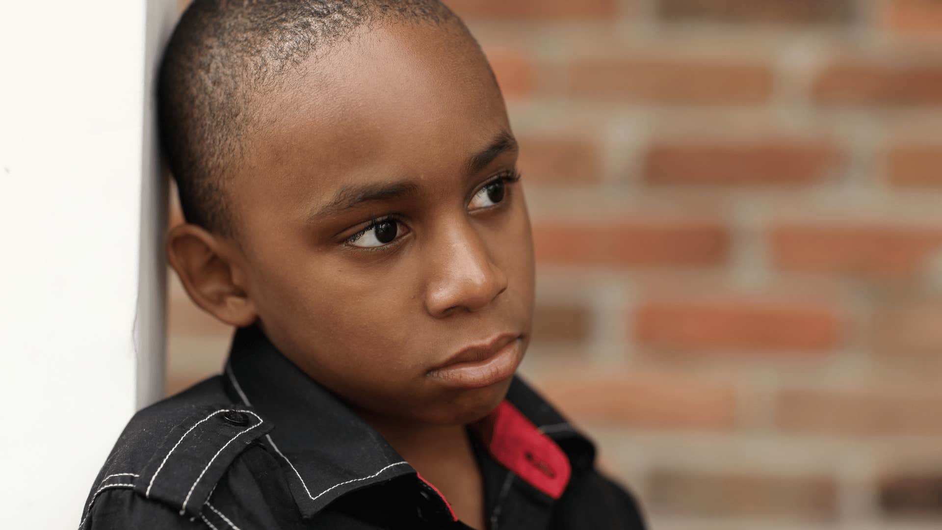 boy who is always looking over his shoulder because he is being raised in a house full of stress