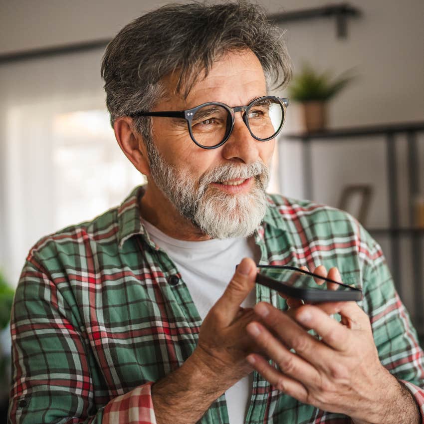 man canceling plans on his phone feeling relieved and happy