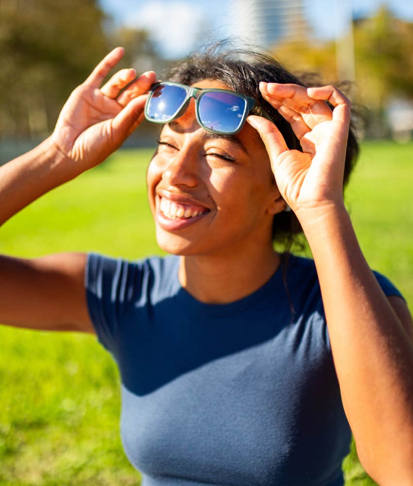 happy person has fun enjoying sunlight on their face