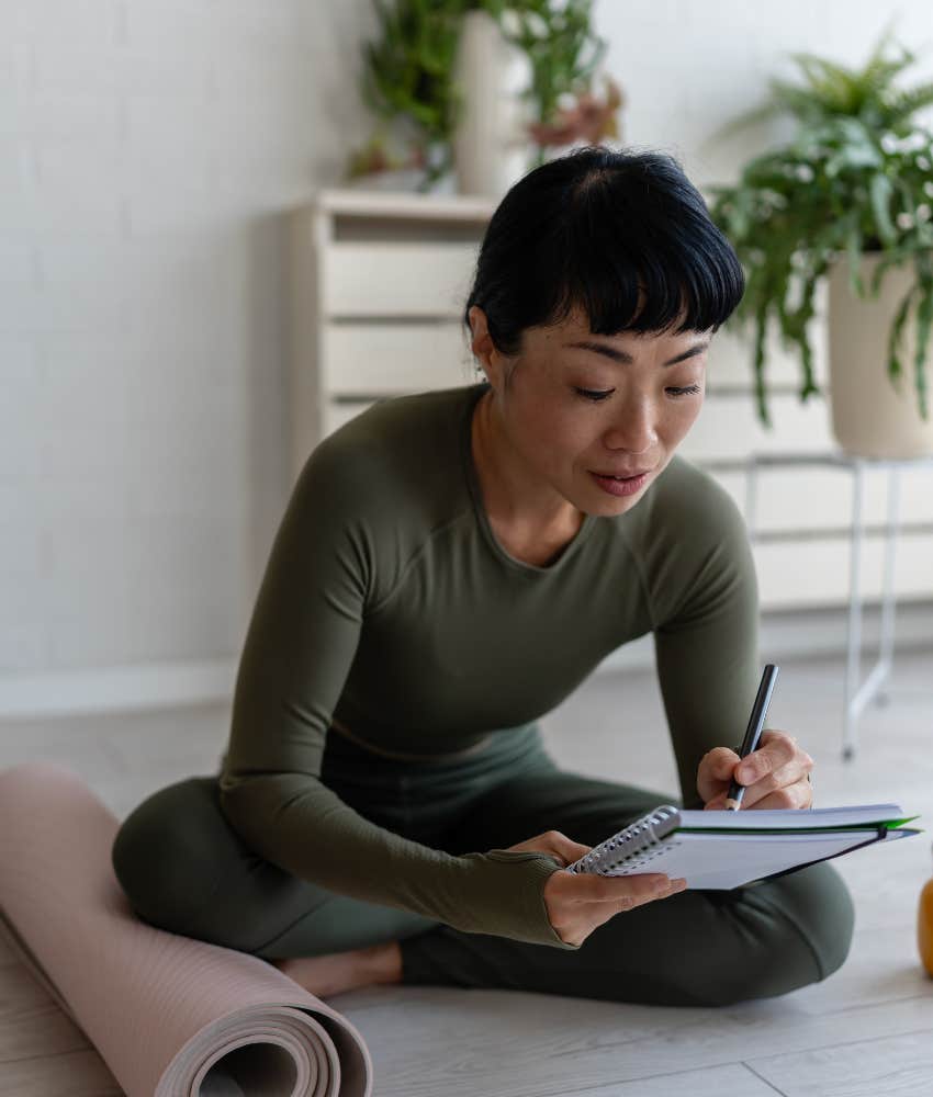 Calm person writes in notebook showing way to stay happy