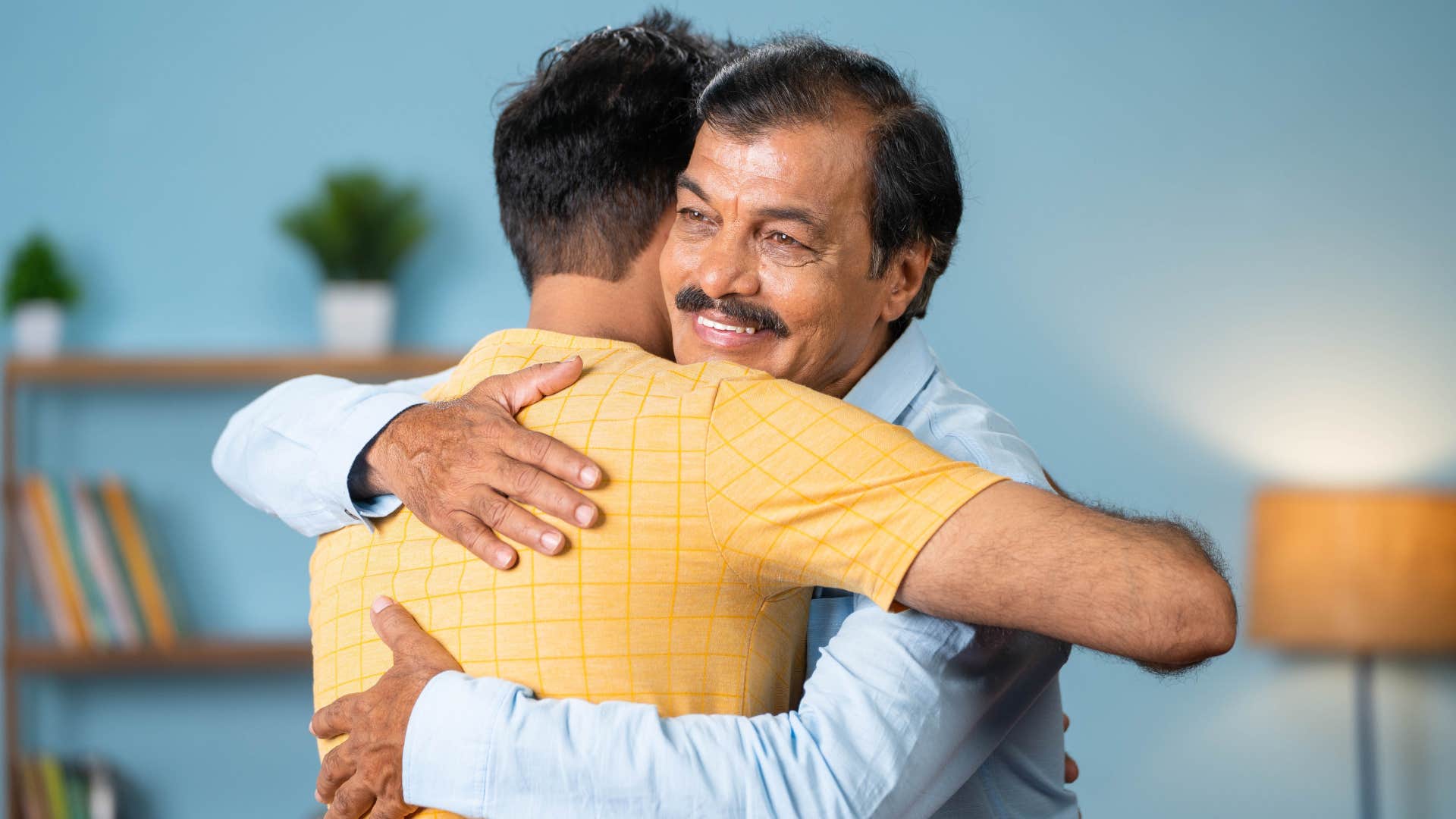 son telling his dad he appreciates him hugging