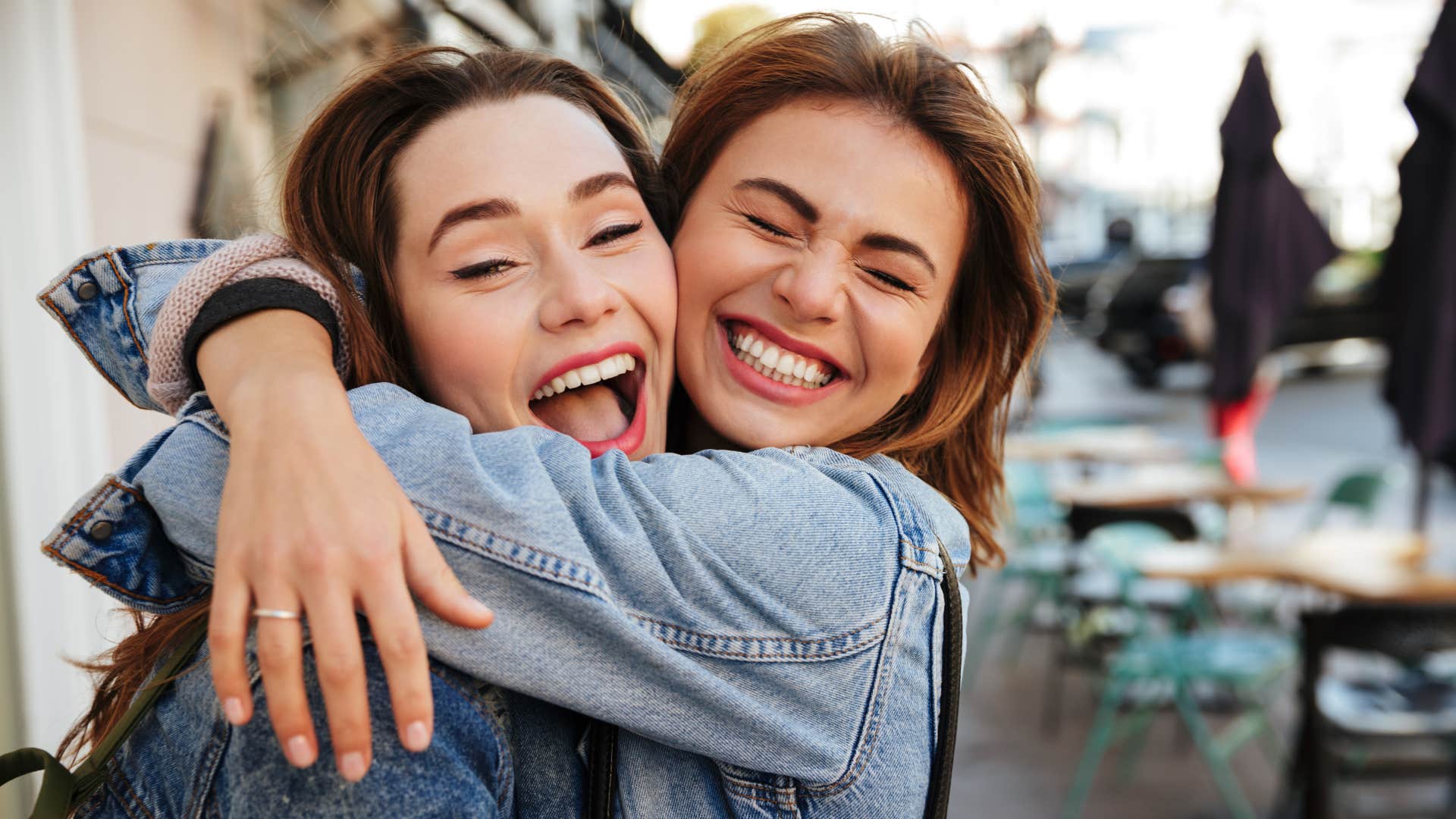 woman telling friend i'm just happy to be here as they hug