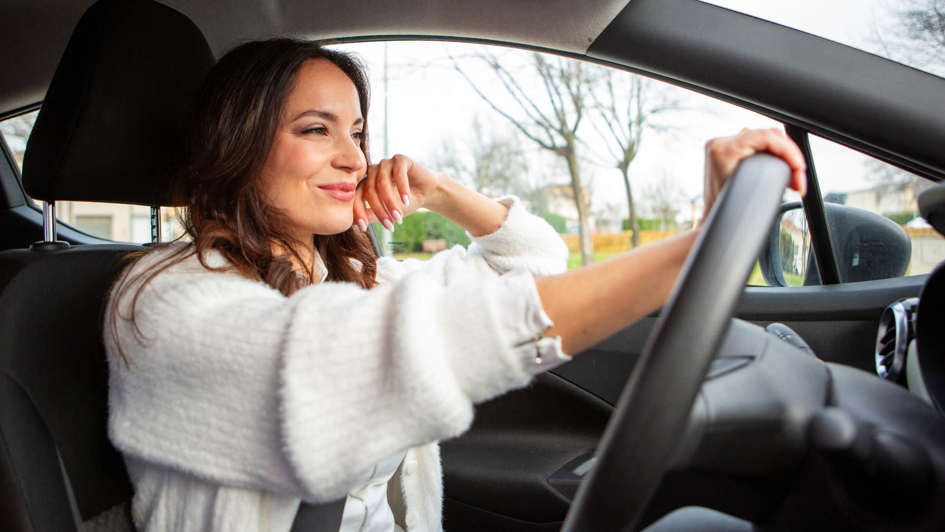 joyful woman driving telling herself let's make today a good day