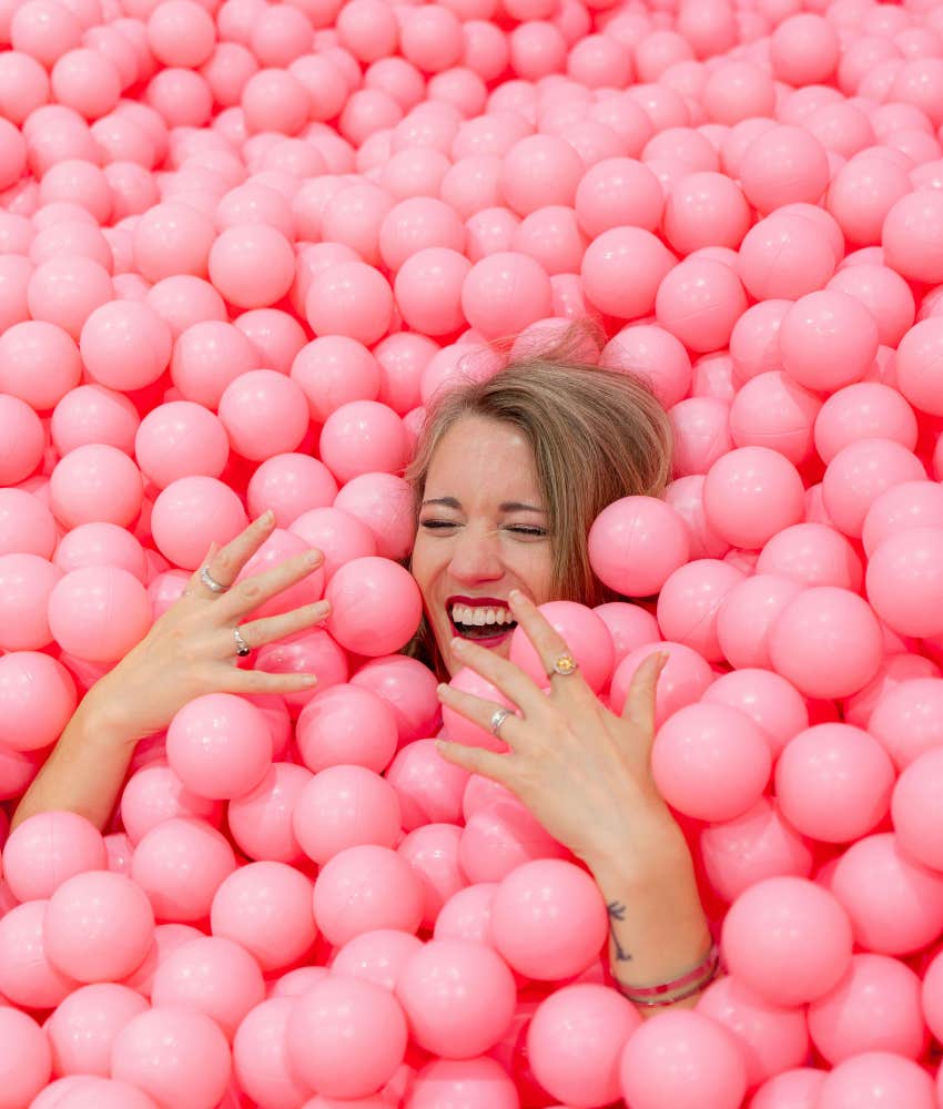 healthy person plays in ball pit