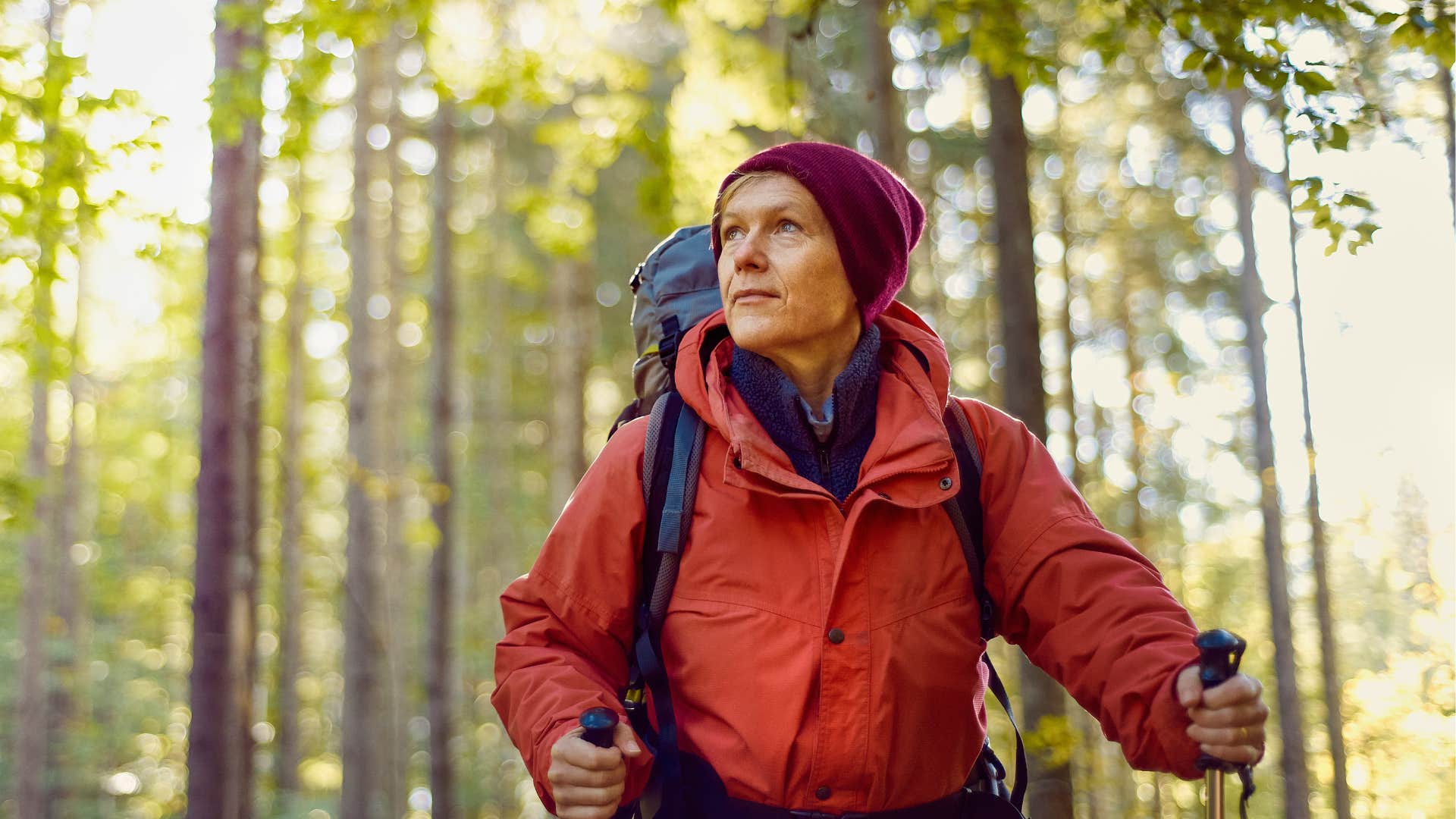 Older woman hiking in the woods for her health and a new hobby
