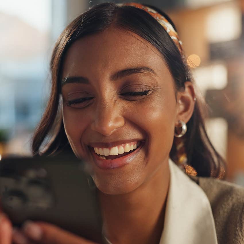 gen z woman on her phone who feels like online astrology communities are welcoming