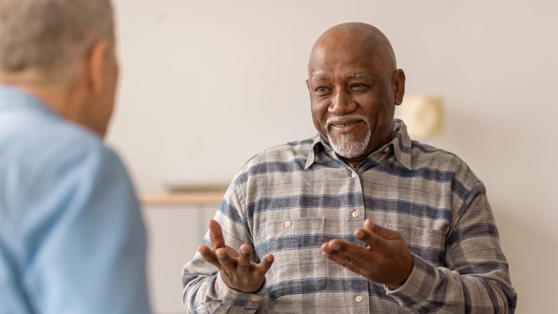 older man in conversation being patient with friend