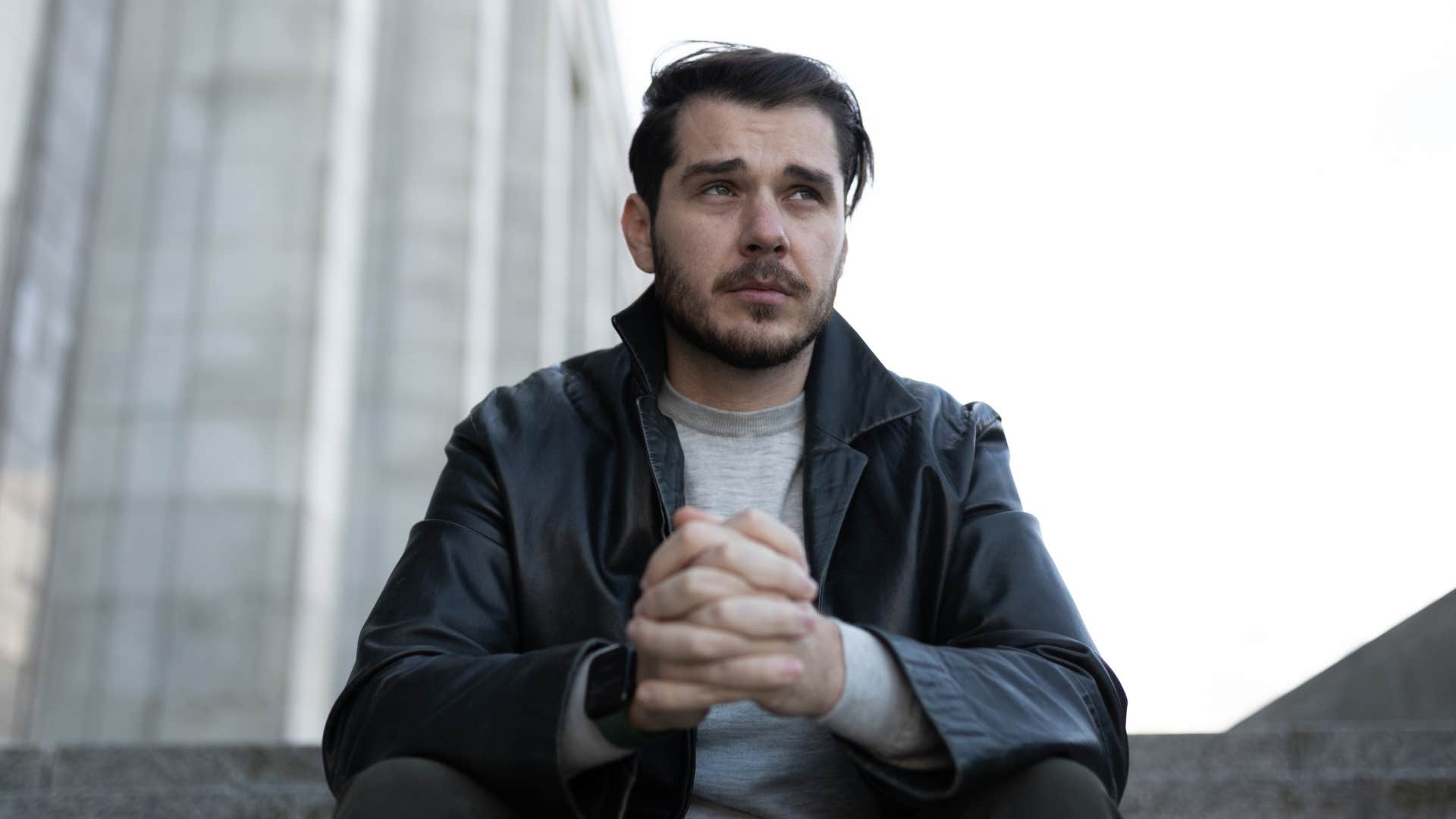 intelligent man who has introverted tendencies sitting outside