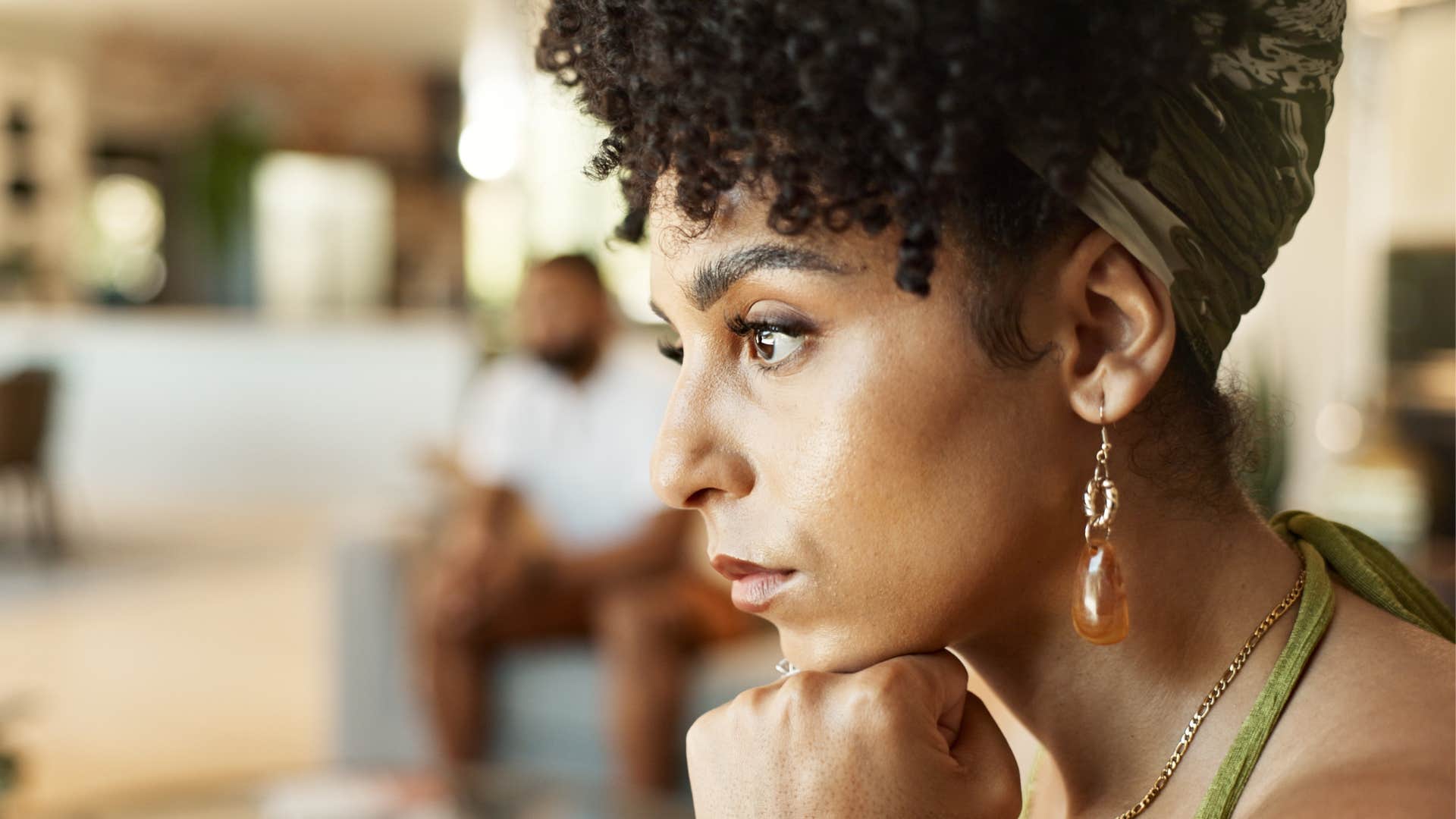 logically thinking woman sitting at home