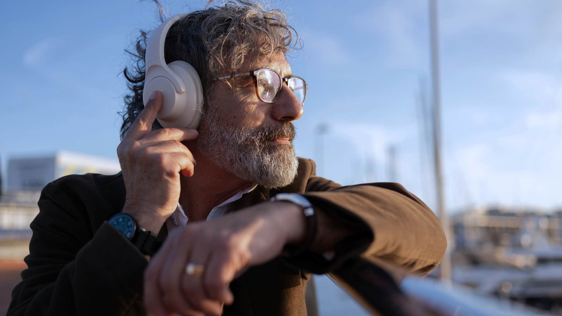 man who's an unconventional person listening to music outside
