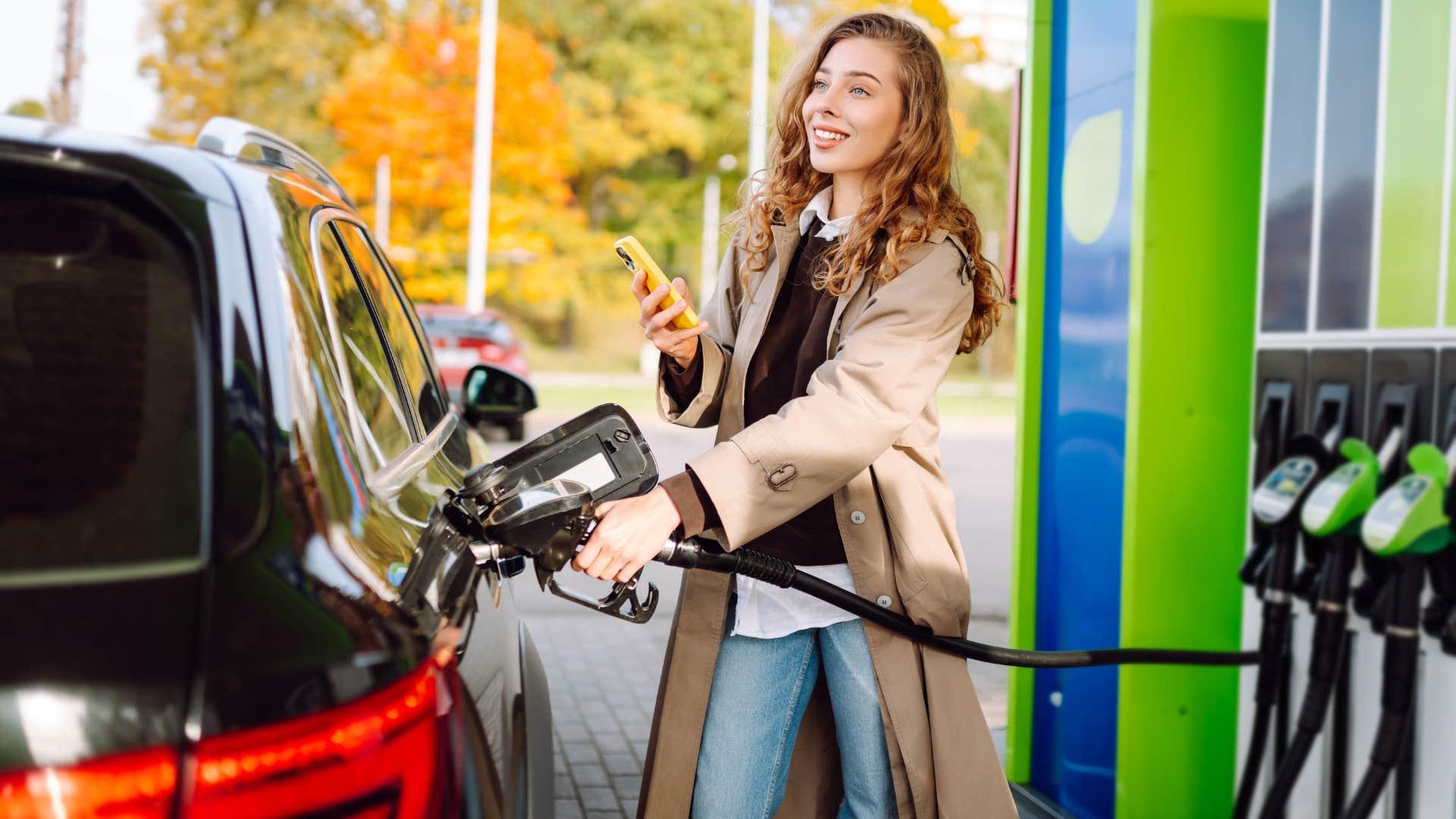woman at a pump and pay gas station