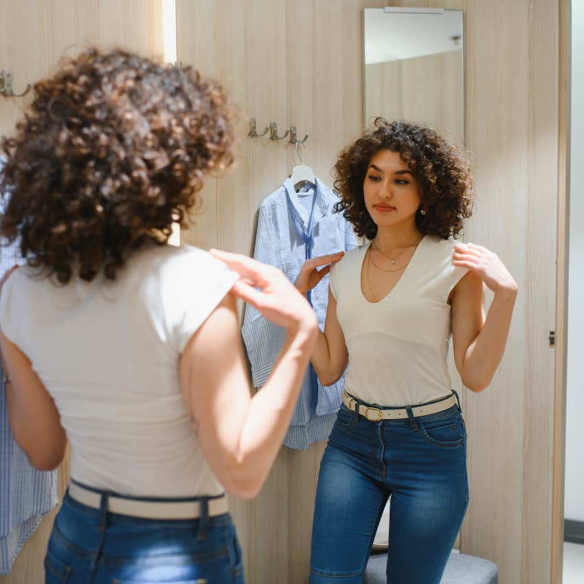 woman trying on clothes dress codes a disproportionately harmful to women