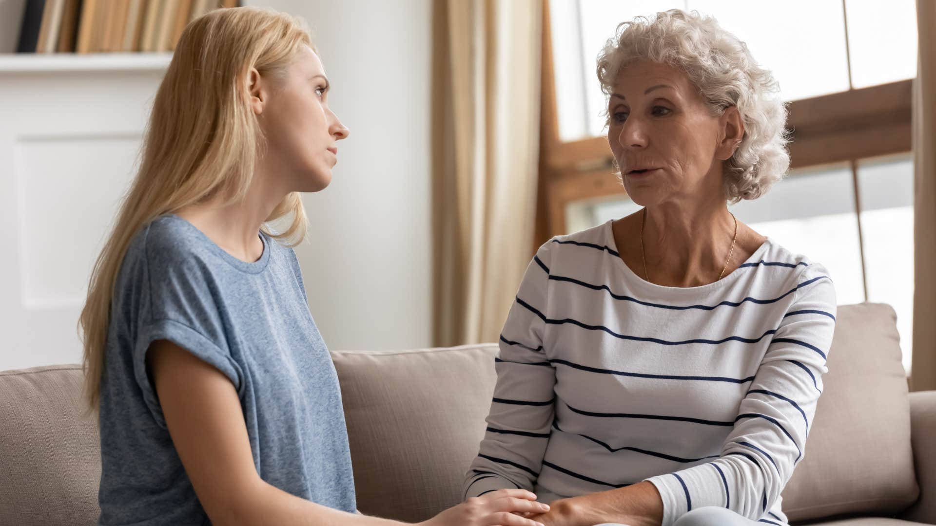 mom talking to adult daughter while downsizing her home