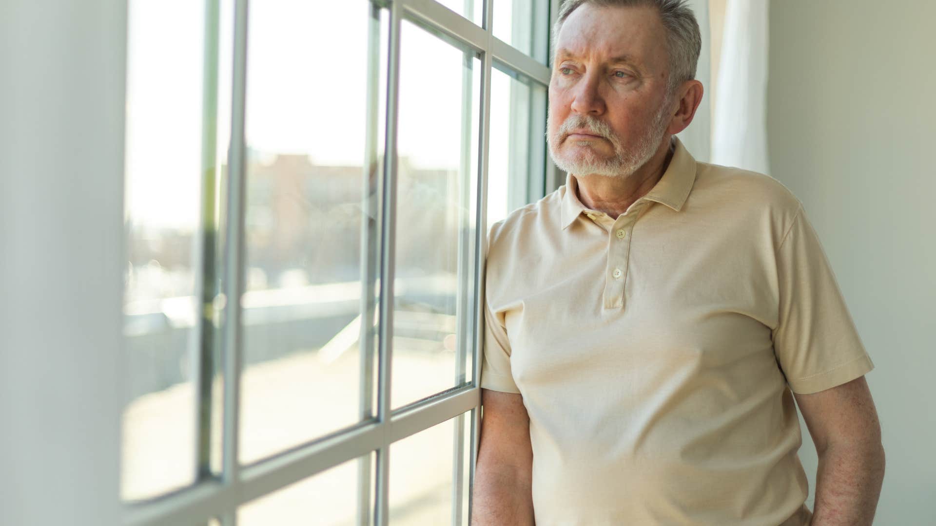 depressed man realizing his home had a story to tell staring out the window