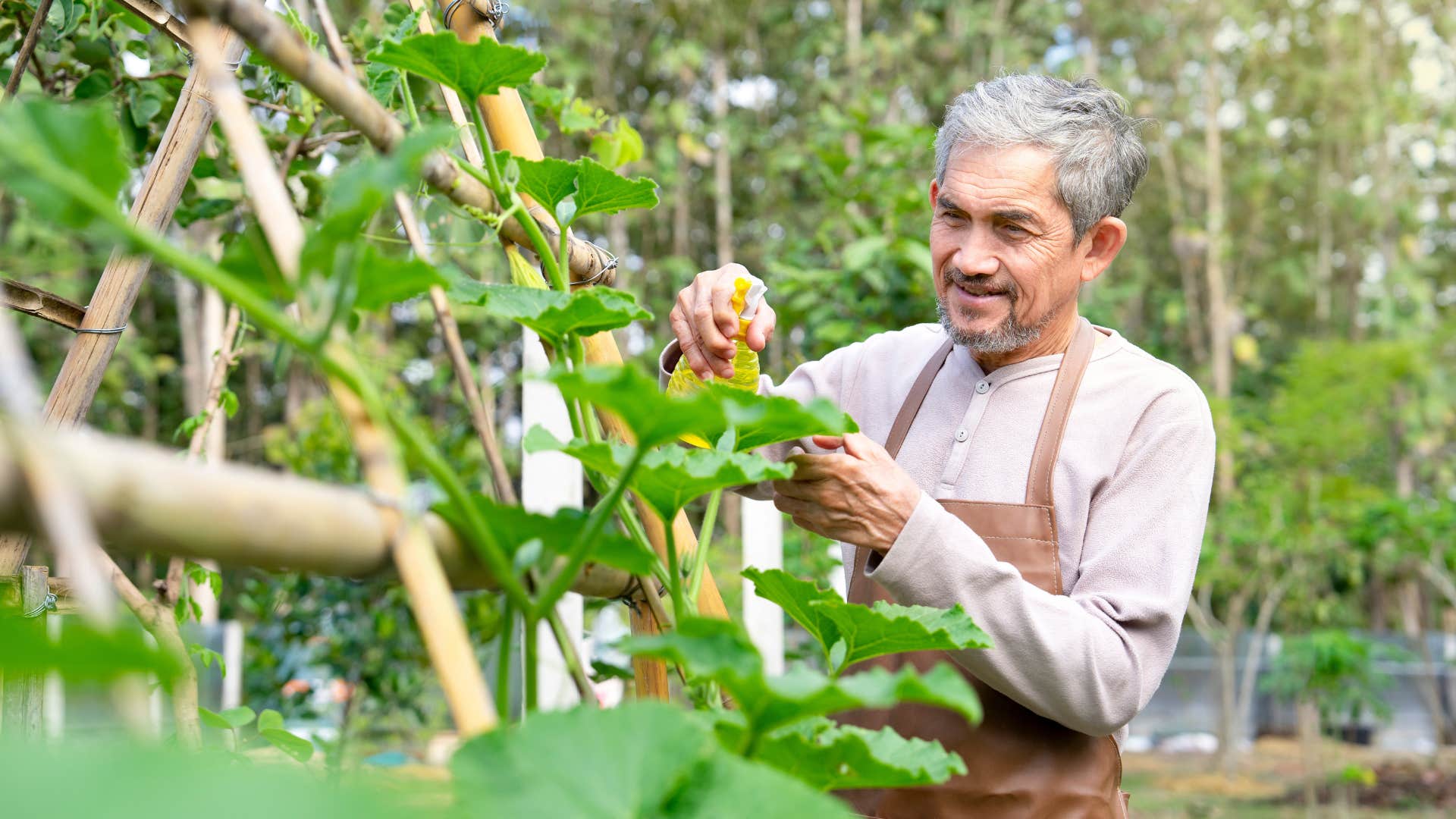 independent older man gardening outside