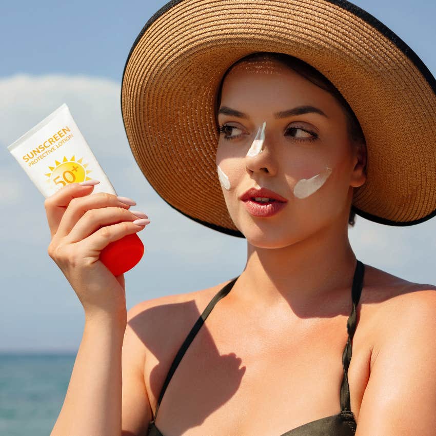 woman applying sunscreen protection against skin cancer