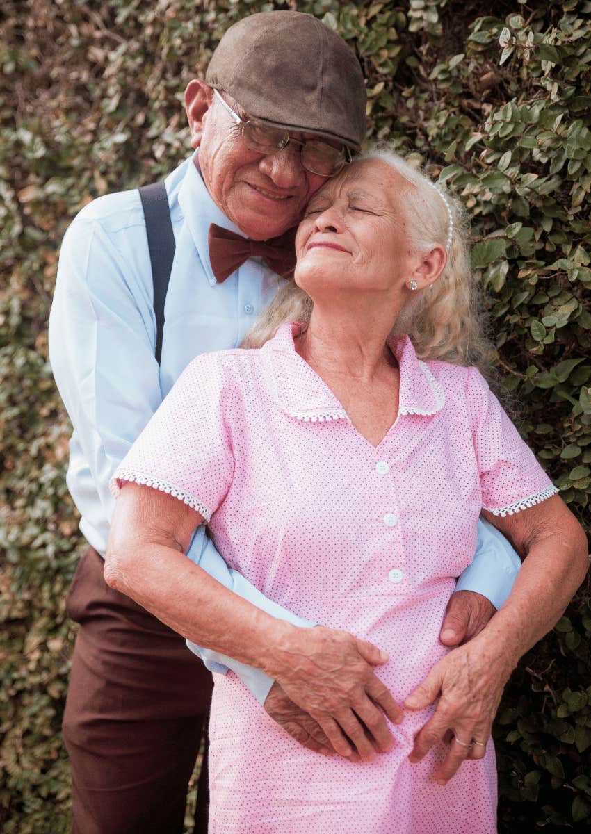 senior man hugging senior woman close