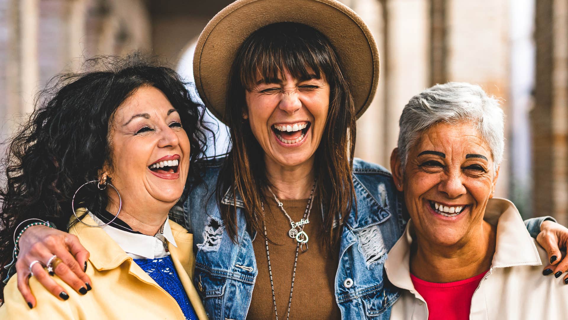 Woman preparing for retirement hugs her daughter and sister happily
