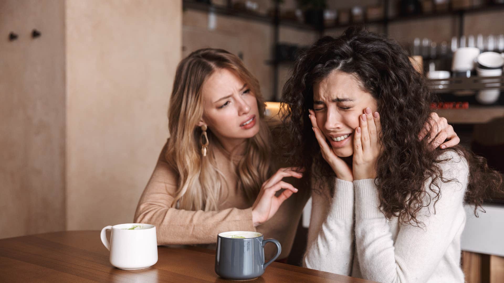 woman playing the victim while friend comforts her
