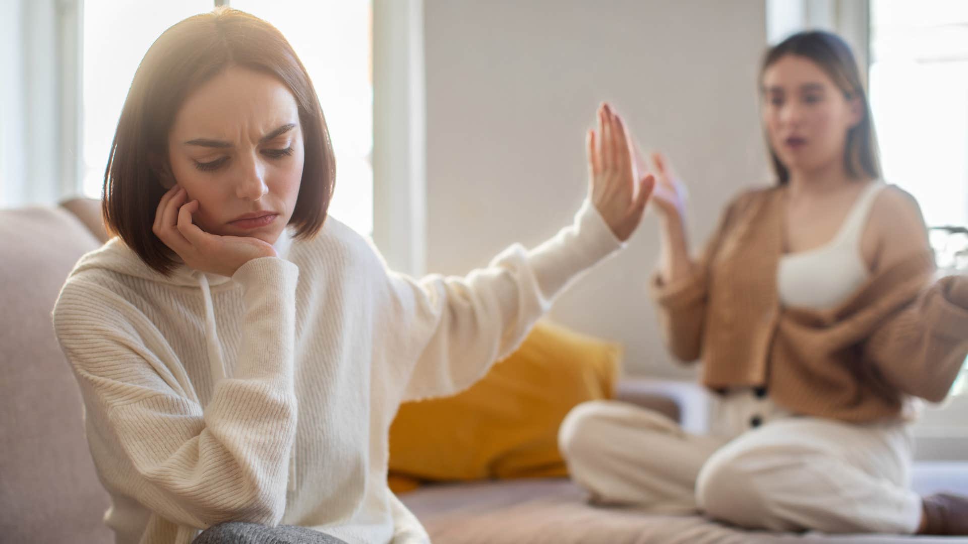 woman in spiritual psychosis pulling away from friend ignoring her