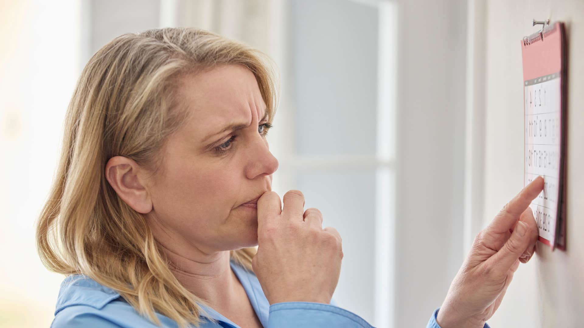 woman looking at calendar losing her train of thought