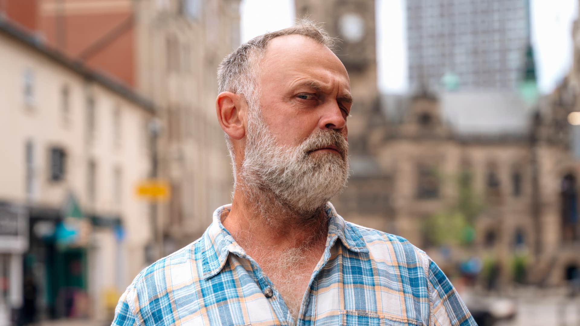 man standing outside feeling suspicious of everything